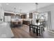 Open-concept kitchen with dark cabinets, stainless steel appliances, center island, and adjacent dining area at 6917 Wheatley Rd, Whitestown, IN 46075