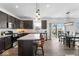 Open-concept kitchen with dark cabinets, stainless steel appliances, center island, and adjacent dining area at 6917 Wheatley Rd, Whitestown, IN 46075