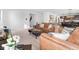 Comfortable living room features a brown leather sofa set, plush carpeting, and an open floor plan to the kitchen at 6917 Wheatley Rd, Whitestown, IN 46075