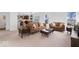 Inviting living room with plush carpeting and a comfortable seating arrangement, perfect for relaxation and entertainment at 6917 Wheatley Rd, Whitestown, IN 46075