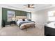 Bright main bedroom features a tray ceiling, panel accent wall, and neutral carpeting at 6917 Wheatley Rd, Whitestown, IN 46075