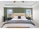 Relaxing bedroom features a tray ceiling, board and batten accent wall, and large windows for natural light at 6917 Wheatley Rd, Whitestown, IN 46075