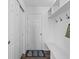 Well-organized mudroom features a bench, coat hooks, and a closet for storage at 6917 Wheatley Rd, Whitestown, IN 46075
