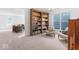 Bright office space featuring built-in bookcases, comfortable seating and natural light that overlooks the home's living room at 6917 Wheatley Rd, Whitestown, IN 46075