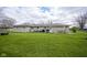 Expansive backyard featuring a well-maintained lawn and outdoor seating area, perfect for entertaining at 712 Valley Dr, Anderson, IN 46011