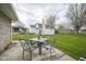 Outdoor patio featuring a table and seating for four with a view of the expansive backyard at 712 Valley Dr, Anderson, IN 46011
