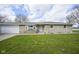 Charming stone facade ranch home with an attached garage and a well-manicured lawn at 712 Valley Dr, Anderson, IN 46011