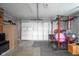 Garage featuring work out area, fitness equipment and a view of the large garage door at 712 Valley Dr, Anderson, IN 46011