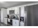 Modern kitchen featuring stainless steel appliances, sleek countertops, and ample cabinet space at 712 Valley Dr, Anderson, IN 46011