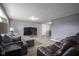 Spacious living room featuring a large TV and comfortable seating arrangements at 712 Valley Dr, Anderson, IN 46011
