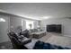 Well-lit living room showcasing plush seating, a TV, and neutral decor at 712 Valley Dr, Anderson, IN 46011