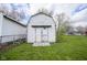 An external view of a painted barn style shed with double doors and a ramp on a grassy lot at 712 Valley Dr, Anderson, IN 46011