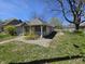 Charming home with a cozy front porch, surrounded by a lawn with some small yellow flowers at 716 Lynn St, Indianapolis, IN 46222