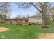 Exterior view of the home showcasing the backyard and deck at 7171 N Orchard Dr, Indianapolis, IN 46236