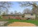Back exterior with a new deck and a mix of brick and siding at 7171 N Orchard Dr, Indianapolis, IN 46236