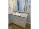 Bathroom vanity with gray countertop, white cabinets and hardware, and hardwood floors at 7171 N Orchard Dr, Indianapolis, IN 46236