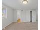 Bedroom with light gray walls, light carpet, a window, closet, and attached bathroom at 7171 N Orchard Dr, Indianapolis, IN 46236
