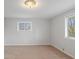 Bedroom with light gray walls, light carpet and two windows at 7171 N Orchard Dr, Indianapolis, IN 46236
