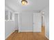 A bedroom with light gray walls, hardwood floors, closet, and a window at 7171 N Orchard Dr, Indianapolis, IN 46236