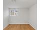 An empty bedroom with oak flooring and a window at 7171 N Orchard Dr, Indianapolis, IN 46236