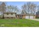 Charming ranch-style home with a well-maintained lawn and a two-car garage showcasing inviting curb appeal at 7171 N Orchard Dr, Indianapolis, IN 46236