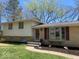 A brick and siding home with a manicured lawn, featuring a bay window and a walkway leading to the front door at 7171 N Orchard Dr, Indianapolis, IN 46236