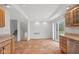 Eat-in kitchen adjacent to staircase features stainless steel appliances, light countertops and ceramic tile floor at 7171 N Orchard Dr, Indianapolis, IN 46236