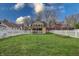 View of an expansive backyard with a white picket fence and a swing set at 720 22Nd St, Columbus, IN 47201
