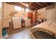 Unfinished basement with laundry, exposed ductwork, and aged walls, with natural light from small window wells at 720 22Nd St, Columbus, IN 47201