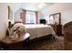 Cozy bedroom with wood furniture, neutral walls, floral bedding, and large window allowing plenty of natural light at 720 22Nd St, Columbus, IN 47201