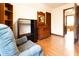 Bedroom featuring hardwood floors, wood dresser, cabinet, and chair at 720 22Nd St, Columbus, IN 47201