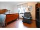Bedroom featuring wood furniture, bed with blue patterned bedding, chair, and hardwood floors at 720 22Nd St, Columbus, IN 47201