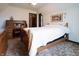 Comfortable bedroom featuring wood furniture, neutral walls, floral bedding, and wood desk with chair at 720 22Nd St, Columbus, IN 47201