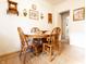 Cozy dining area features a wooden table and chairs, enhanced by natural light and decorative wall art at 720 22Nd St, Columbus, IN 47201
