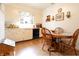 Dining area with wood-style floors, wooden table and chairs, and bright lighting from a nearby window at 720 22Nd St, Columbus, IN 47201