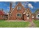 Charming brick home featuring a gabled roof, arched entry and walkway, and mature landscaping at 720 22Nd St, Columbus, IN 47201