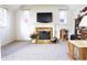 Bright room featuring a fireplace with decorative mantle and built-in display cabinet at 720 22Nd St, Columbus, IN 47201