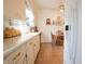 Bright kitchen with light-colored cabinets, practical layout, and a view into an adjacent dining area at 720 22Nd St, Columbus, IN 47201