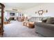 Spacious living room featuring neutral carpet, comfortable seating, and an inviting fireplace at 720 22Nd St, Columbus, IN 47201