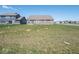 Large backyard showcasing well-maintained lawns with neighborhood homes visible in the background at 7209 Glen Park Ln, Indianapolis, IN 46259