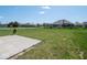 Spacious backyard featuring a concrete patio, well-maintained lawn, and beautiful neighborhood views at 7209 Glen Park Ln, Indianapolis, IN 46259