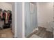 Bathroom with a shower and curtain, along with an adjacent walk-in closet at 7209 Glen Park Ln, Indianapolis, IN 46259