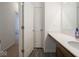 Bright bathroom with white cabinets, a large mirror and an open doorway at 7209 Glen Park Ln, Indianapolis, IN 46259