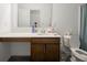 Well-lit bathroom with a modern vanity, large mirror, and tiled floors at 7209 Glen Park Ln, Indianapolis, IN 46259