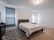 Bright bedroom featuring neutral carpet, a dark bed and grey rug at 7209 Glen Park Ln, Indianapolis, IN 46259