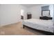Cozy bedroom featuring neutral carpet and a view into an adjoining bathroom at 7209 Glen Park Ln, Indianapolis, IN 46259
