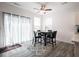 Dining area with a modern table set, decorative rug, and natural light from large windows at 7209 Glen Park Ln, Indianapolis, IN 46259