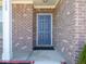 Close-up of the elegant front door with brick surround and classic hardware, creating a welcoming entrance at 7209 Glen Park Ln, Indianapolis, IN 46259