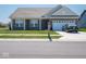 Charming single-story home featuring a brick facade, attached garage, and well-manicured front lawn at 7209 Glen Park Ln, Indianapolis, IN 46259