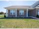 Charming front exterior with manicured lawn, brick facade, and inviting covered porch with classic columns at 7209 Glen Park Ln, Indianapolis, IN 46259